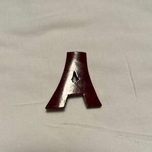 Vintage wooden pin with the letter A.